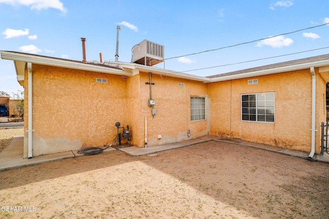 rear view of property featuring central AC