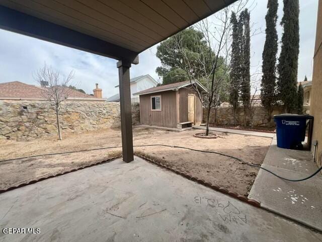 view of yard featuring a patio area and a shed