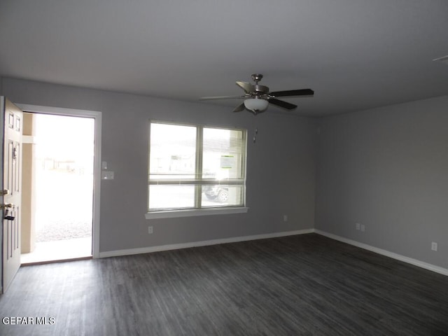 unfurnished room with ceiling fan and dark hardwood / wood-style flooring