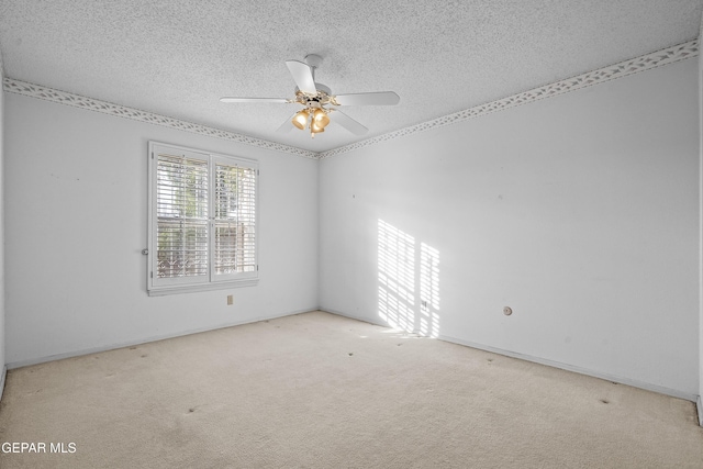 unfurnished room with ceiling fan, light colored carpet, and a textured ceiling