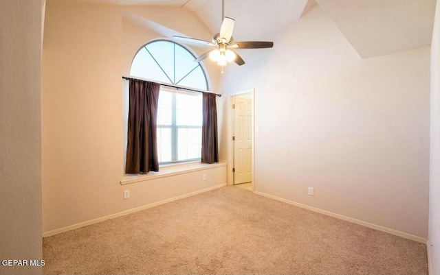 carpeted spare room with high vaulted ceiling and ceiling fan