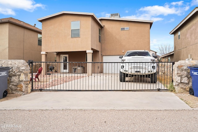 view of gate with a garage