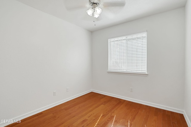 unfurnished room featuring baseboards, a ceiling fan, and wood finished floors