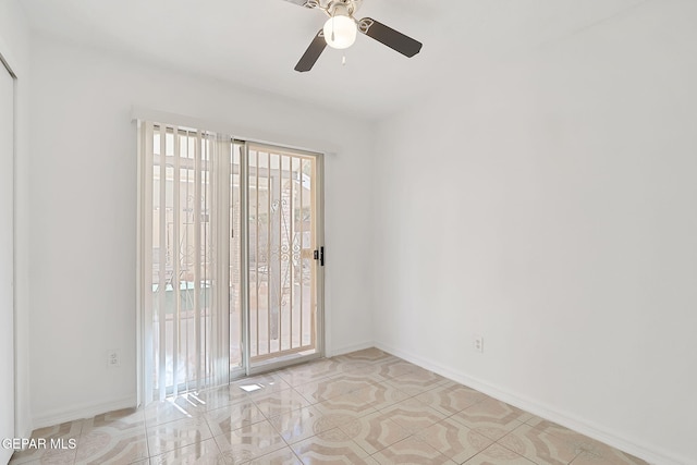 empty room with a ceiling fan, baseboards, and light tile patterned floors