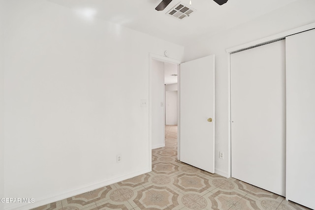 unfurnished bedroom with ceiling fan, a closet, visible vents, and baseboards