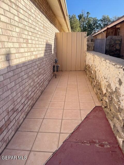 view of side of home with brick siding