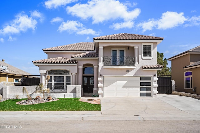 mediterranean / spanish-style home featuring a garage, a balcony, and french doors