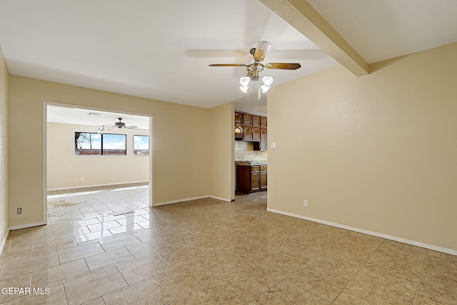 unfurnished living room with beamed ceiling, light tile patterned flooring, sink, and ceiling fan