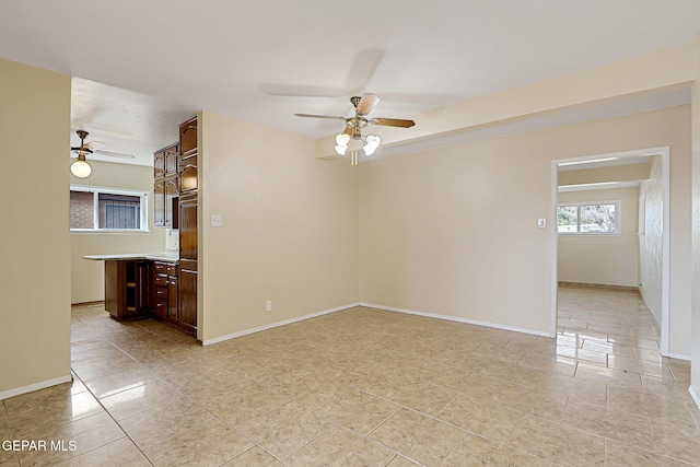 tiled spare room featuring ceiling fan