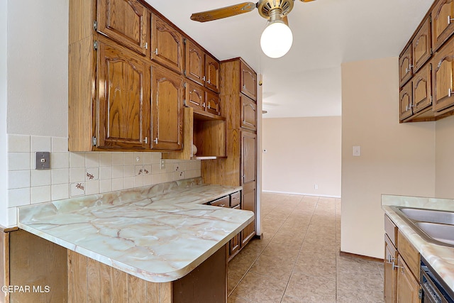 kitchen with sink, dishwasher, ceiling fan, light tile patterned flooring, and decorative backsplash