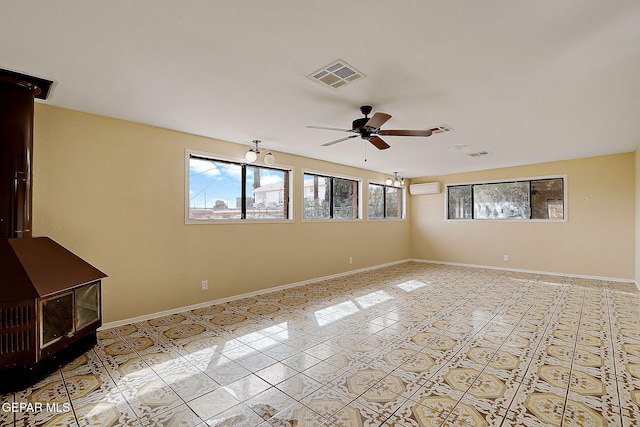 unfurnished room featuring ceiling fan, a wood stove, light tile patterned floors, and a wall unit AC