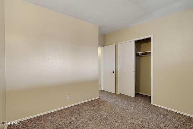 unfurnished bedroom featuring a closet and carpet