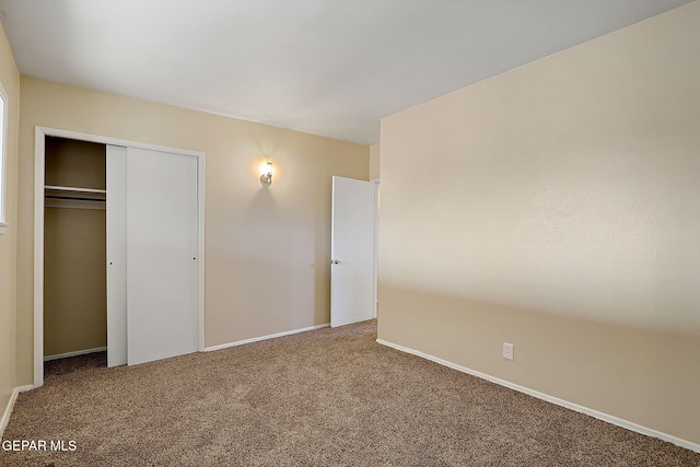 unfurnished bedroom with a closet and carpet