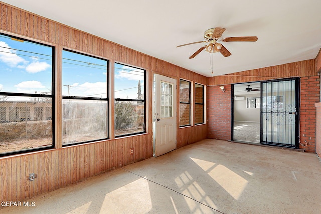 unfurnished sunroom featuring ceiling fan