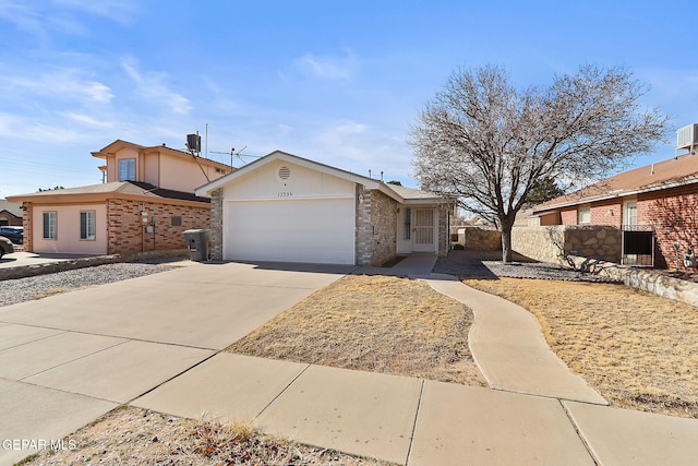 single story home with a garage and central air condition unit