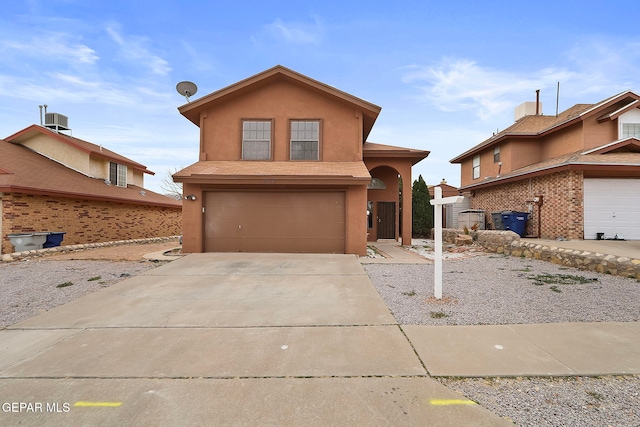 view of front property featuring cooling unit and a garage