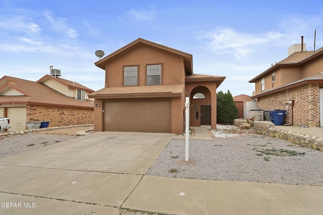 front of property featuring a garage and central air condition unit