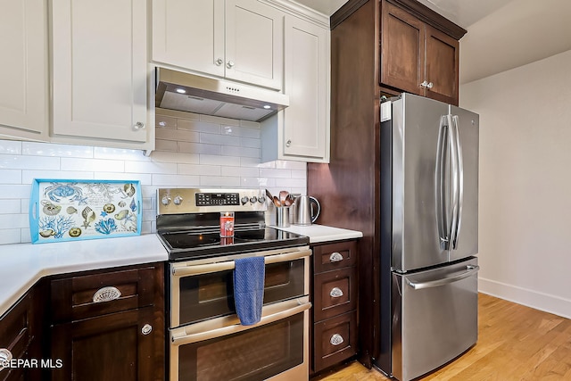 kitchen featuring stainless steel appliances, white cabinetry, backsplash, and dark brown cabinetry