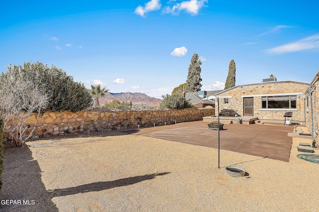 view of yard featuring a mountain view and a patio area