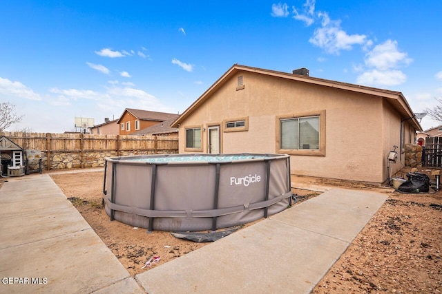 exterior space featuring a fenced in pool