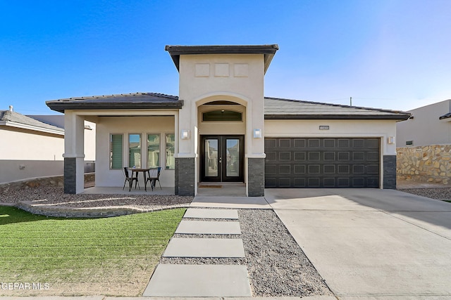 view of front of home with a garage and french doors