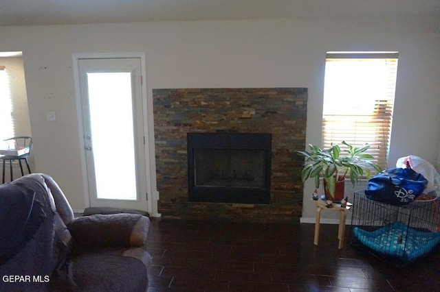 living room featuring dark hardwood / wood-style flooring and a fireplace