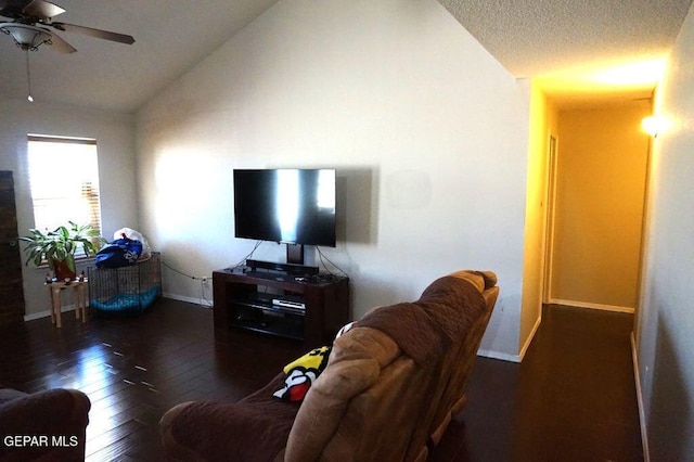 living room with a textured ceiling, vaulted ceiling, dark hardwood / wood-style floors, and ceiling fan