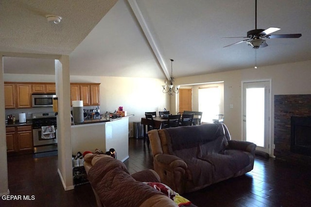 living room with ceiling fan, high vaulted ceiling, dark wood-type flooring, and a fireplace