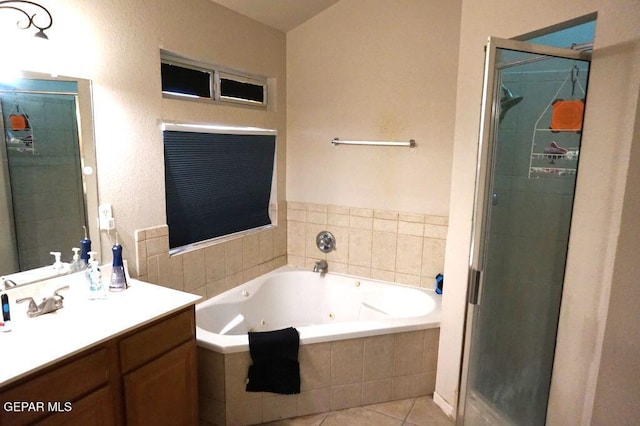 bathroom featuring vanity, tile patterned flooring, and plus walk in shower