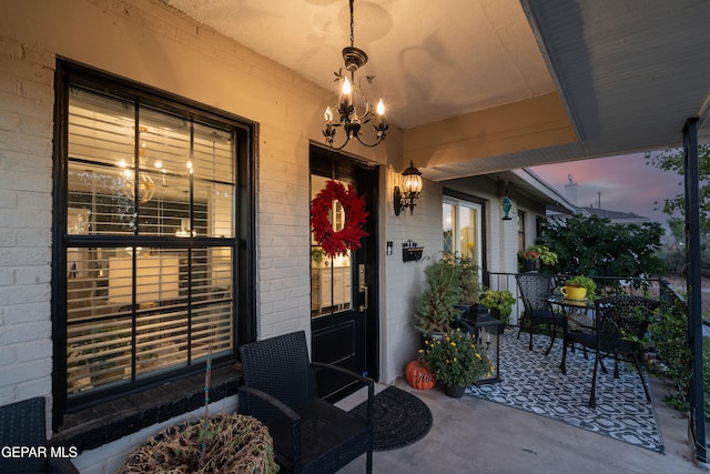 exterior entry at dusk featuring a patio