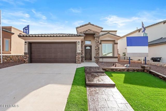 mediterranean / spanish home featuring a garage and a front yard