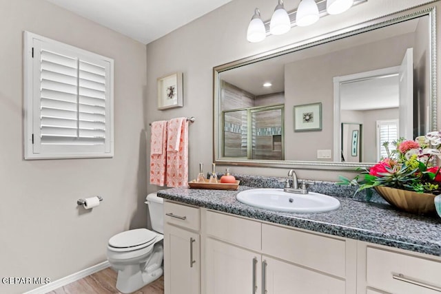 bathroom featuring an enclosed shower, vanity, hardwood / wood-style floors, and toilet