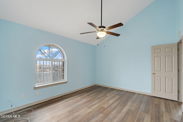 unfurnished room featuring ceiling fan, high vaulted ceiling, and light wood-type flooring