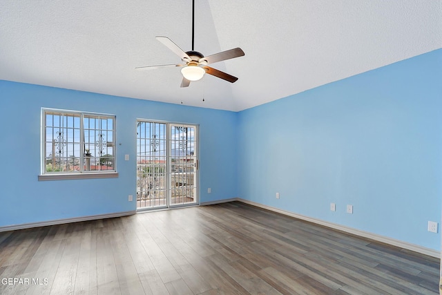 empty room featuring hardwood / wood-style flooring, ceiling fan, and a textured ceiling