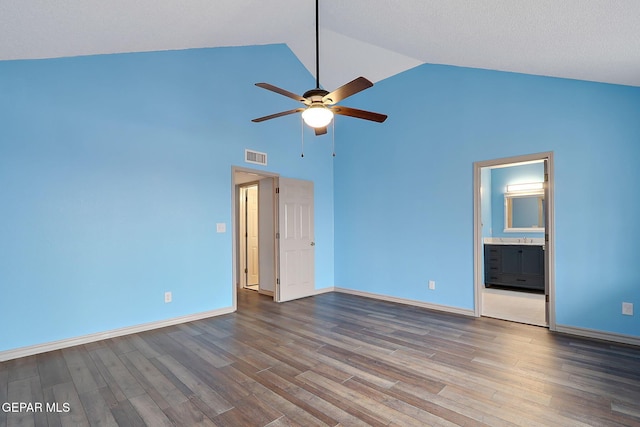 unfurnished bedroom with ceiling fan, wood-type flooring, connected bathroom, and high vaulted ceiling