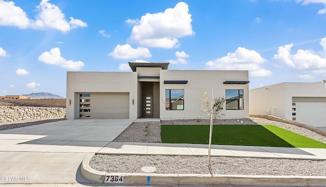 modern home featuring a mountain view and a garage