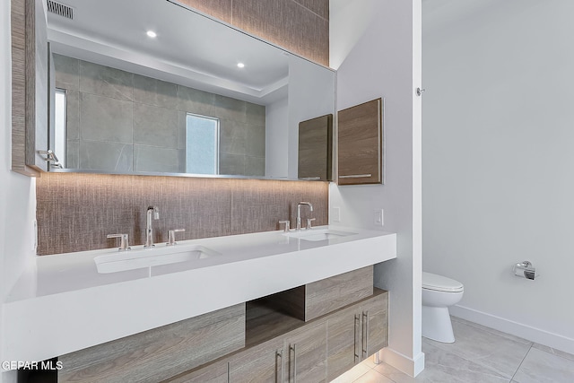 bathroom with tile patterned floors, vanity, and toilet