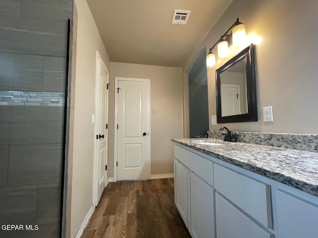 bathroom with hardwood / wood-style flooring and vanity