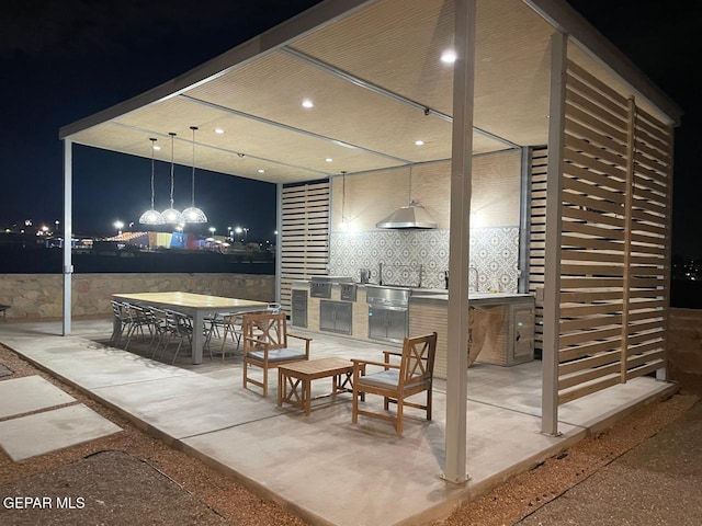 patio at night with area for grilling