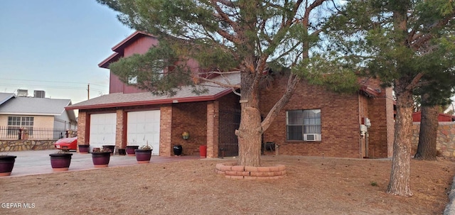 back of house featuring a garage