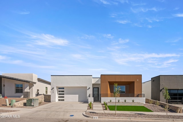 contemporary house featuring central AC unit and a garage