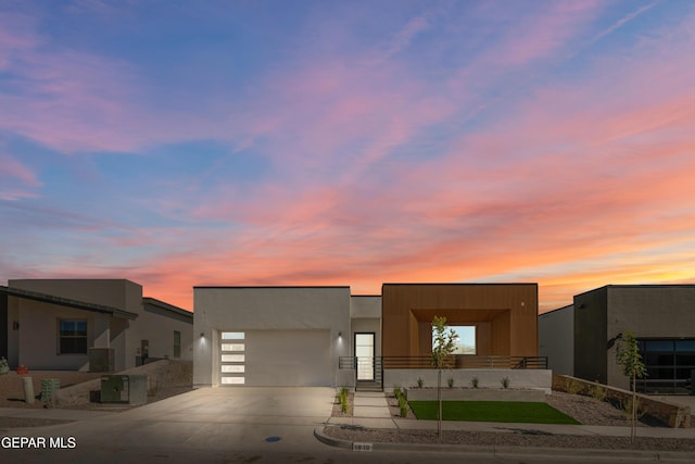 view of front of property featuring central AC and a garage