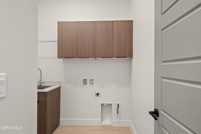 laundry area featuring sink, cabinets, washer hookup, hookup for an electric dryer, and light hardwood / wood-style floors