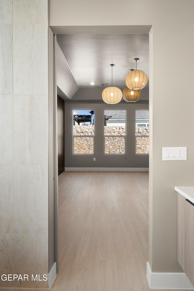 interior space with hardwood / wood-style floors and vaulted ceiling