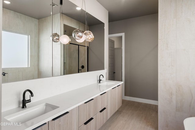 bathroom featuring vanity, wood-type flooring, and walk in shower