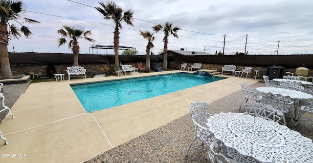 view of swimming pool with a pergola, pool water feature, and a patio area