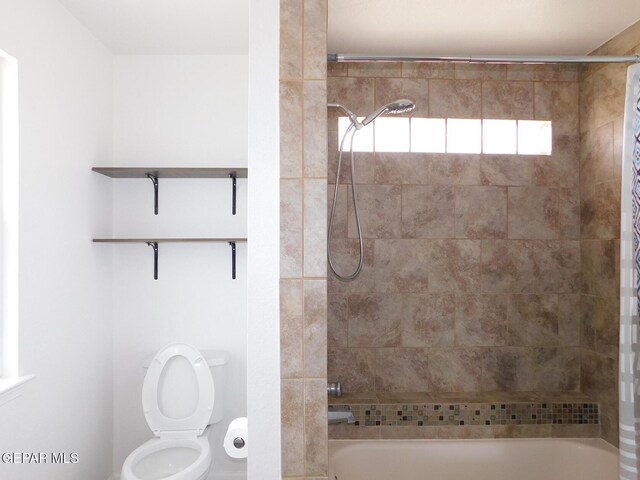 bathroom with shower / bath combo with shower curtain and toilet
