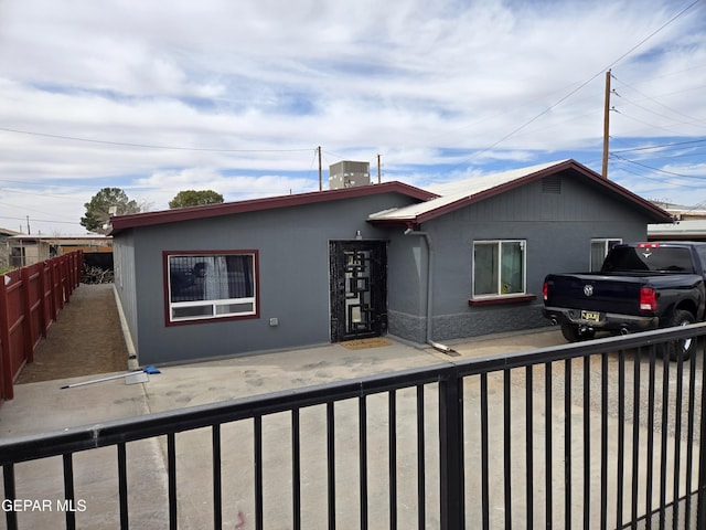 view of front of property with central air condition unit and fence private yard