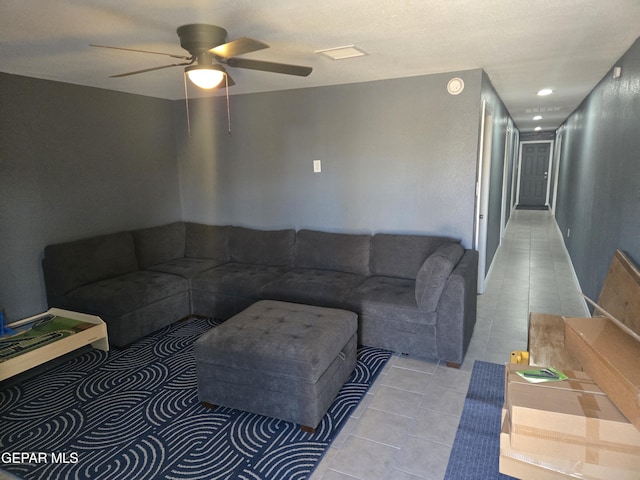 living room featuring light tile patterned flooring and a ceiling fan