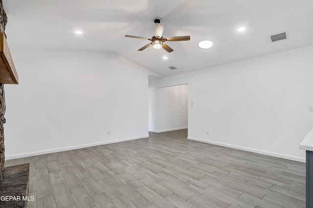 unfurnished living room featuring lofted ceiling, ceiling fan, and light wood-type flooring